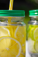 a cocktail of lemon and lime is poured into jars with handles lids and tubes
