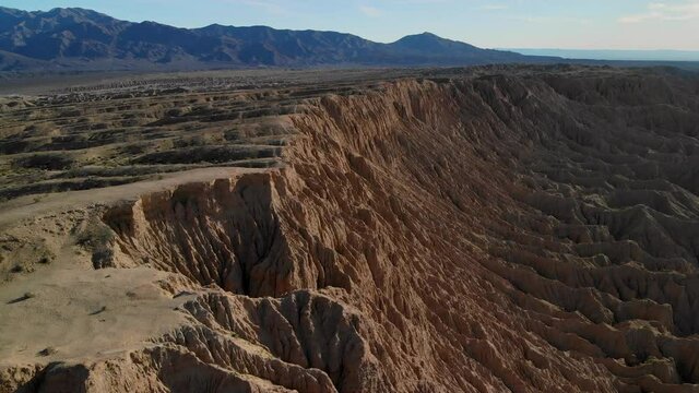 Cinematic aerial flyover of badlands at Font's Point in Anza Borrego Desert State Park in Southern California