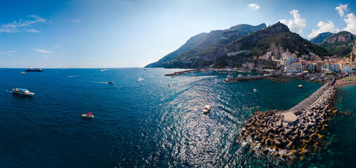 Aerial view high pesolution panorama of the Amalfi city, Summer day. Travel and vacation to Europe mountains. Copy space, the most popular beach. Breakwater. Houses and hotels. Italy