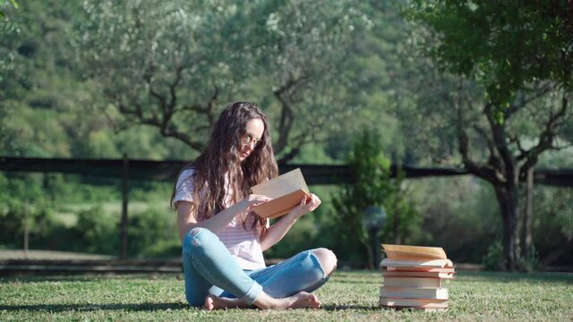 Recreation outdoors, inspiration and creativity concept. Girl sitting in the garden and reading book, concentrated female student studying at home. Self-education concept
