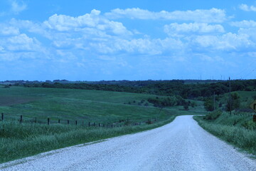 Fototapeta na wymiar Country Road with hills and blue skies