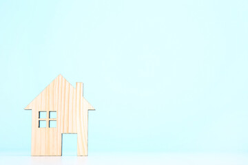 Wooden house model on blue background