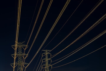 A High-voltage electricity transmission pylons in the night time.