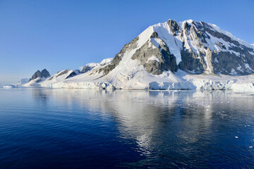 Antarctic landscape, glacier and mountain, with reflection in water, Antarctica
