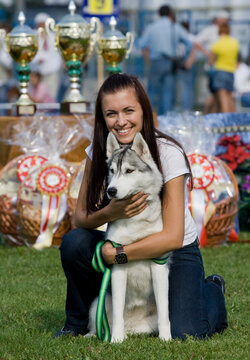 Happy owner with her siberian husky dog