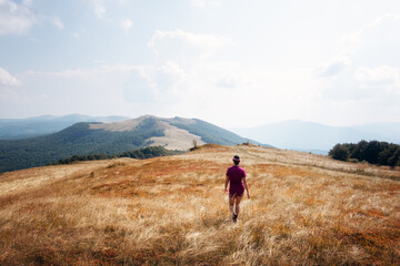 Alone girl in against the backdrop of an incredible autumn mountains landscape