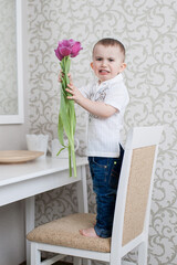 Cute baby boy with tulip