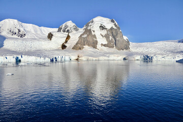 Fototapeta na wymiar Antarctic landscape, glacier and mountain, with reflection in water, Antarctica