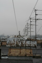 Building roof, old television antennas, satellite dishes, dullness, depression, rusty antennas, chimney
