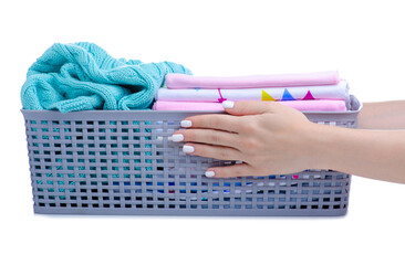 basket with stack baby clothing in hand on white background isolation