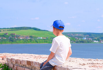 young boy on the beach. travel in 2020. Sea view. hot summer day