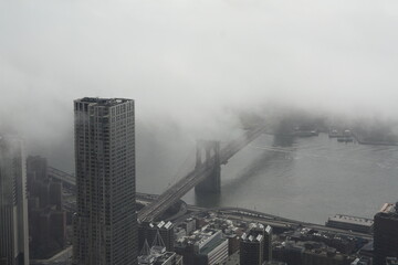Famous Aerial view of the Brooklyn Bridge in New York City, USA with beautiful cloudy sky and...