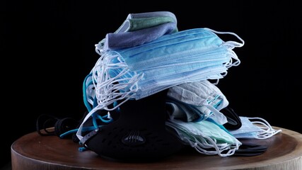 Pile of medical and dust pollution face masks. Mandatory face masks by law concept. Used PPE...
