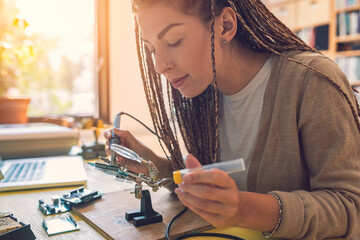 Close up of beautiful woman soldering stock photo