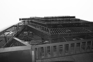 Beautiful Old Apartment Building Exterior with a Fire Escape in black and white, red-brick, monochrome, Manhattan, New York City, USA, America.