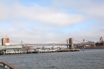 Fototapeta premium Famous Brooklyn Bridge in New York City, USA with beautiful blue sky and Manhattan skyline and Manhattan Bridge in background, America.