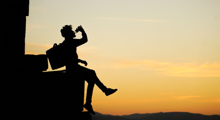 Fototapeta premium Silhouette of man drinking water