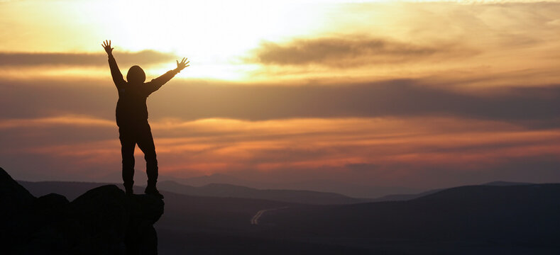 silhouette of man with arms raised