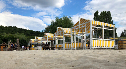yellow and white striped beach cabanas