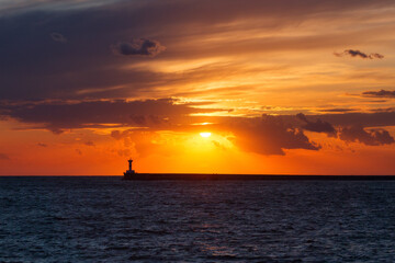 Beautiful sunset on the embankment of Sevastopol Crimea . The sun sets in the sea. Very beautiful seascape, view of the sea, waves and sky with clouds.