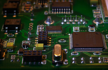 Macro close-up shot of green circuit board, computer motherboard Components: microcircuits,...