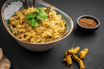 Kichari decorated with parsley leaves, cardamom, turmeric and tortillas