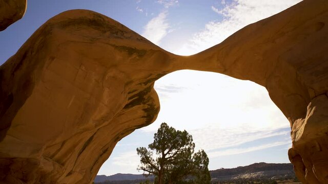 Cinematic tracking shot of Metate Arch at Devils Garden in Grand Staircase Escalante National Monument in Utah
