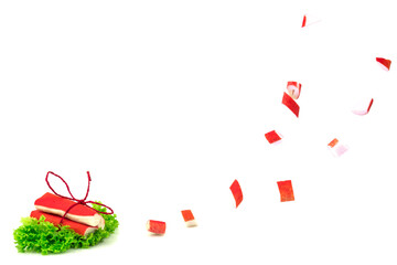 Red crab sticks of surimi on green lettuce with tie and slices i