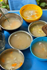 Fish soup is cooked on the fire. Ears in an iron bowl in nature.