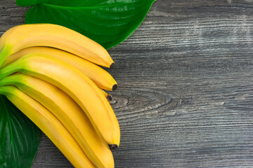 Bunch of raw organic yellow bananas on wooden background - 369313734