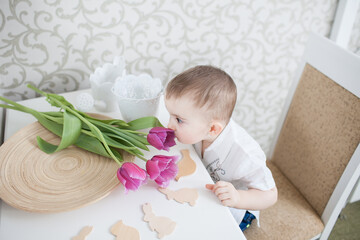 Cute baby boy with tulip