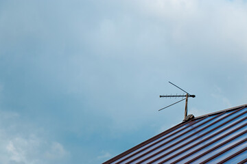 Fototapeta premium Top view with blue sky cloud and antenna. Part of roof with one antenna with copy space. Minimal think. Minimal thing. Conceptual minimalism. Conceptual photography
