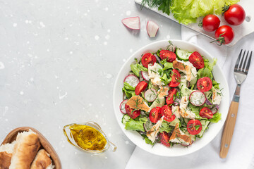 Delicious vegetarian Fattoush or Arab salad with pita bread, fresh vegetables on plate. Middle...