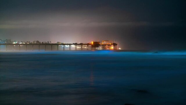 Time Lapse Telephoto Shot Of Bioluminescent Glowing Waves At Ellen Browning Scripps Memorial Pier In San Diego, California