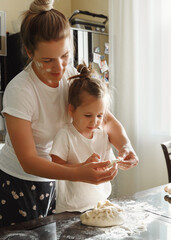 mother and daughter baking cookies