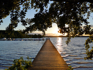 wooden pier at sunset at a lake in brandenburg 