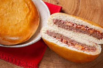 .Brazilian roasted appetizer stuffed with hamburger meat, ham and tomato sauce.