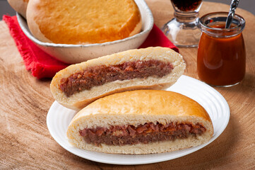 .Brazilian roasted appetizer stuffed with hamburger meat, ham and tomato sauce.