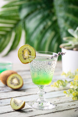 Cold cocktail kiwi drink in a glass with fresh fruits on white background