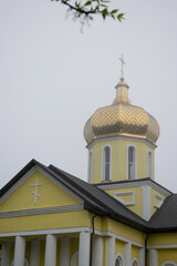 Fototapeta na wymiar Orthodox church with golden domes on a cloudy day close-up. Religion concept