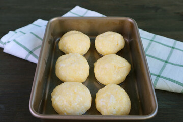Ball shaped dough in the baking tray for baking Brazilian cheese bread or Pao de Queijo