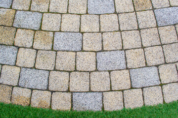 Paved squares and rectangles are laid out on the surface. The paving stones are laid out in a...