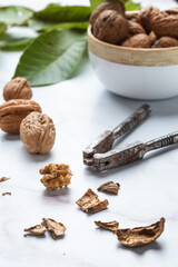 peeled walnut with a nutcracker on a marble table. Selective focus