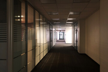 closed office due to coronavirus pandemic, nobody in office. Light turned off, doors are closed.