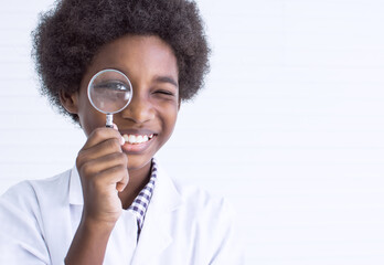 Portrait of african black boy or student holding magnifying glass for studying