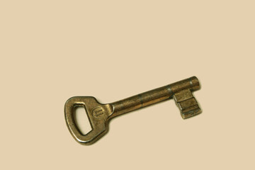 Worn door lock key made of metal. The key to the locks of the house doors. Worn and cracked lock key.