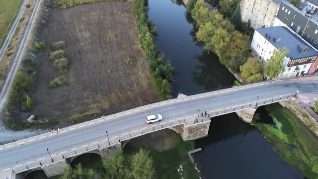 River and bridge in Cacabelos, village of Leon. Spain. Camino de Santiago. Aerial Drone Footage