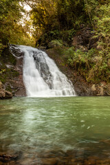 A beautiful waterfall with a small lake in the woods