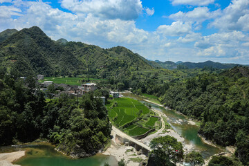 Chinese rural village on a sunny day, farm, mountains and river