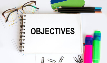 Paper with text objective on wood table